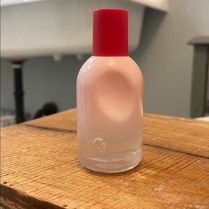 Glossier Blush Pink Bottle with Bold Red Cap